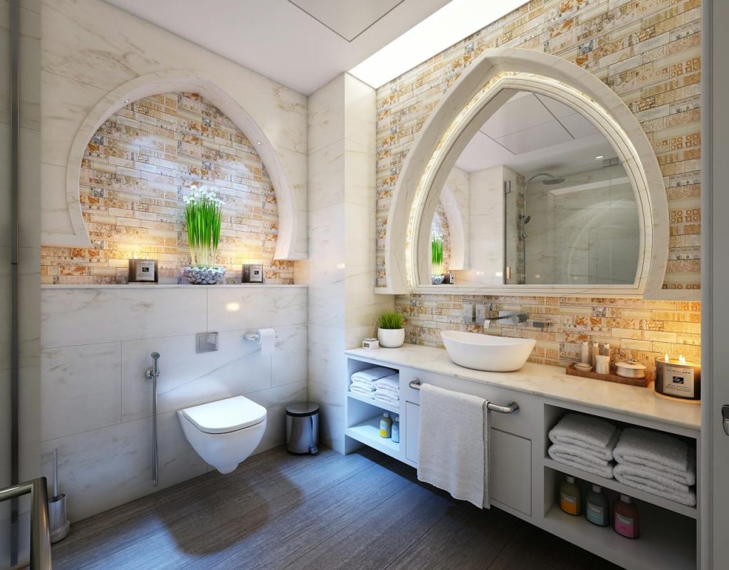 white-towel-on-gray-steel-bar-342800 Elegant modern bathroom with marble tiles, ambient lighting, and stylish decor.